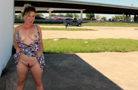 Fat amateur bares her landing strip twat in public with a butt plug in her ass