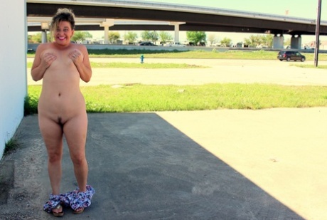 Fat amateur bares her landing strip twat in public with a butt plug in her ass