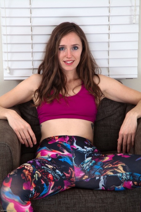 Long-haired British babe Anya strips her hot leggings and rubs her hairy pussy